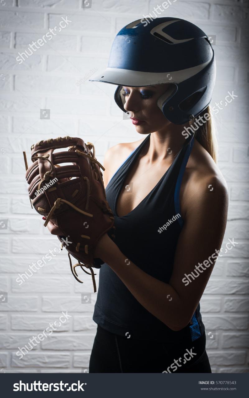 stock-photo-beautiful-young-female-softball-or-baseball-player-in-studio-570778543.jpg