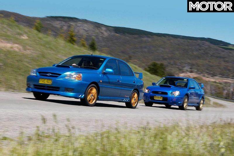 2005-Subaru-Impreza-WRX-STi-vs-Kia-Rio-comparison-feature-on-road.jpg