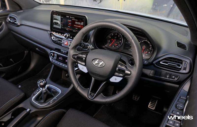 2021_Hyundai_i30_N_hatchback_polar_white_interior_driver_cockpit.jpg