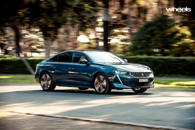 2021_Peugeot_508_GT_Fastback_Celebes_Blue_Australia_dynamic_front_road_EDewar.jpg