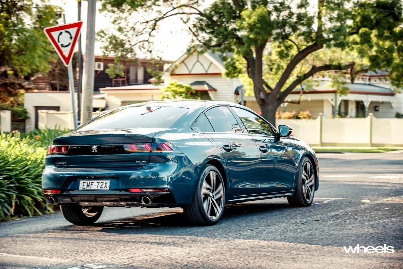 2021_Peugeot_508_GT_Fastback_Celebes_Blue_Australia_dynamic_rear_town_EDewar.jpg