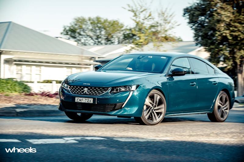 2021_Peugeot_508_GT_Fastback_Celebes_Blue_Australia_dynamic_front_street_EDewar.jpg