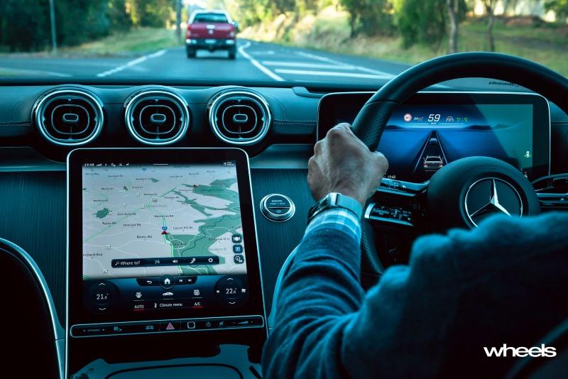 2022_Mercedes-Benz_C300_Spectral_Blue_Metallic_Australia_interior_driving_01.jpg