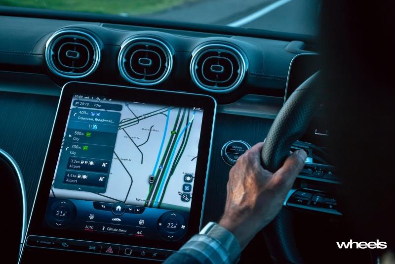 2022_Mercedes-Benz_C300_Spectral_Blue_Metallic_Australia_interior_driving_02.jpg