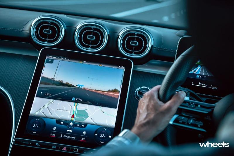 2022_Mercedes-Benz_C300_Spectral_Blue_Metallic_Australia_interior_driving_03.jpg