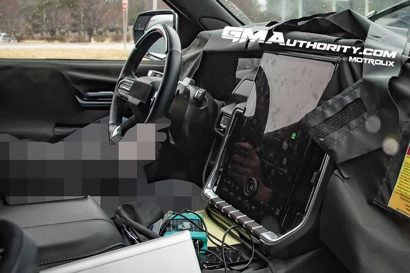 2025-GMC-Yukon-Denali-Onyx-Black-GBA-Prototype-Spy-Shots-Undisguised-April-2024-Interior-001-door-panel-steering-wheel-center-stack-infotainment-display-screen.jpg