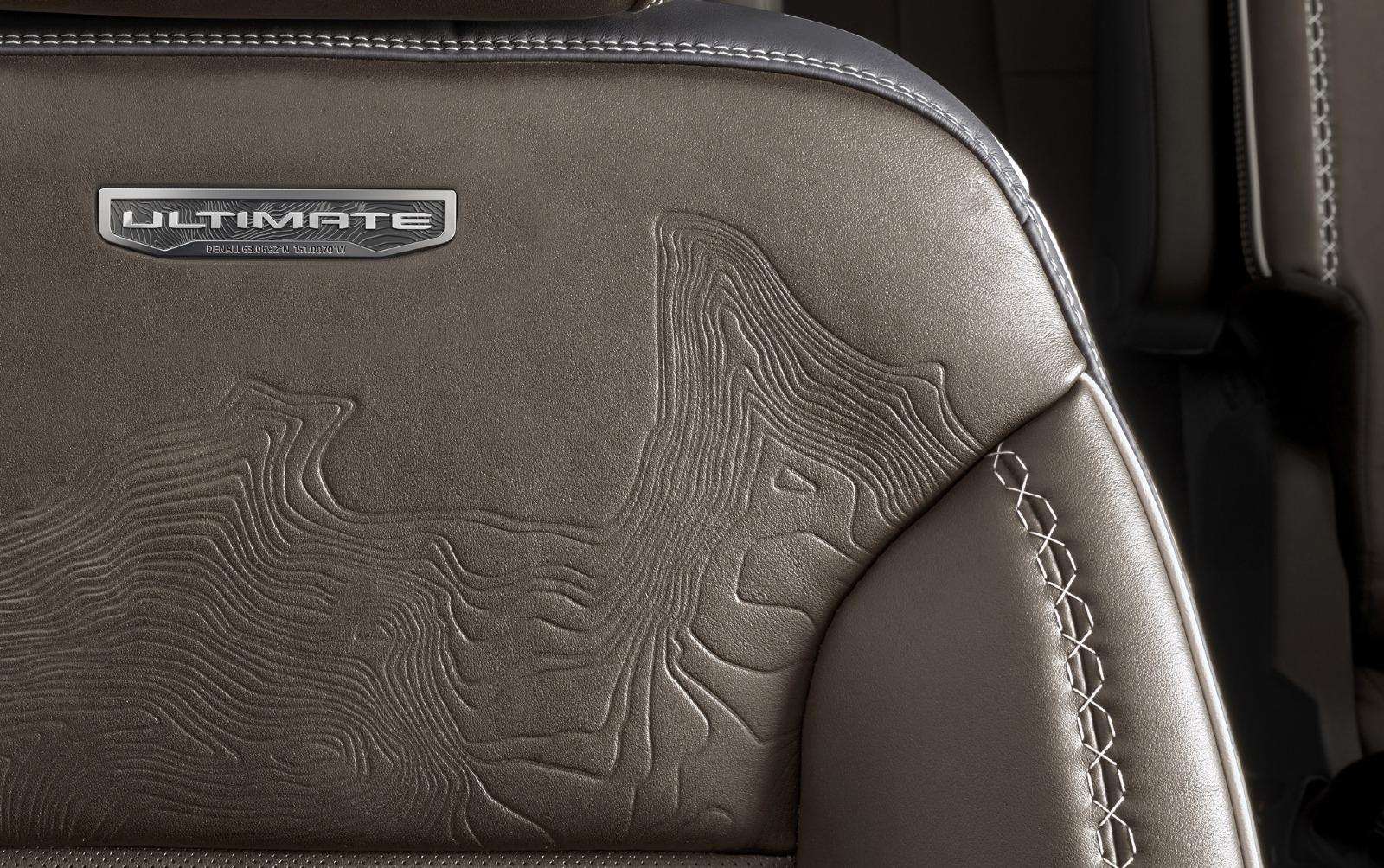 2026-GMC-Acadia-Denali-Ultimate-Press-Photos-Interior-006-Denali-Ultimate-logo-seat-topography-detail.jpg