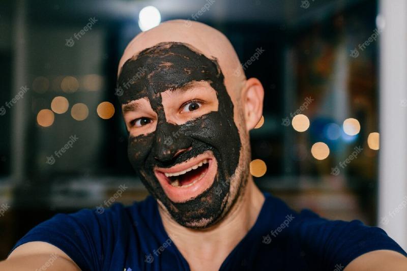 man-with-charcoal-mask-on-his-face-taking-selfie_149066-4466.jpg
