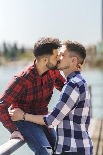 vertical-photo-of-a-gay-couple-kissing-on-a-jetty_475667-2333.jpg